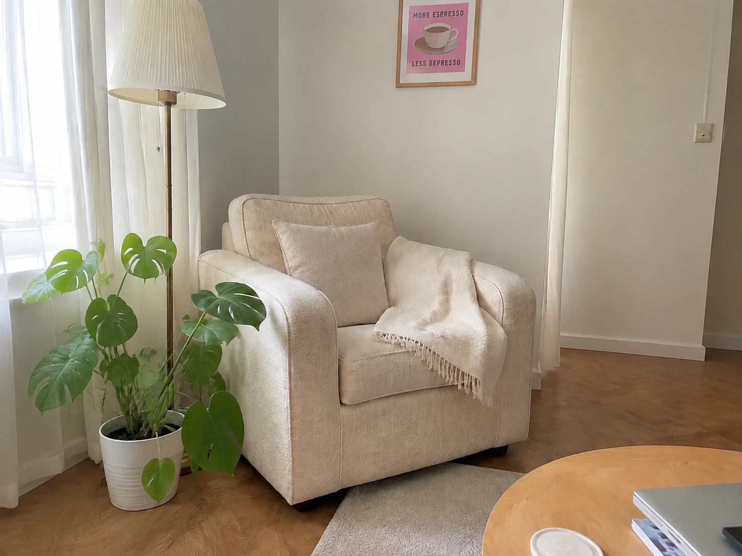 Styled living room corner with cream armchair and plant, rubbish bin and bag removed with floor and wall restored