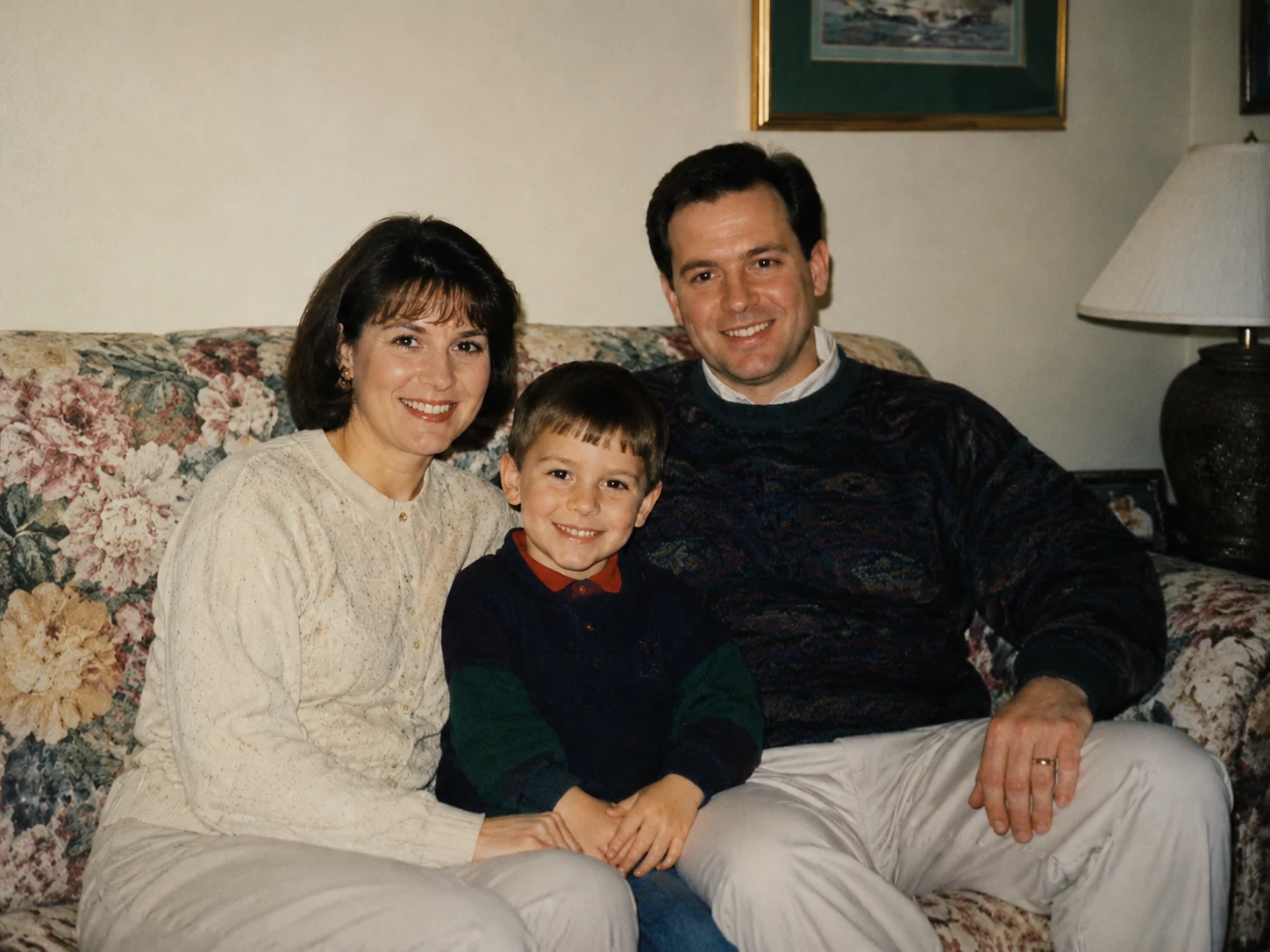 Restored 1995 family photo with diagonal scratch, dust spots, and date stamp removed, faces and living room scene fully intact