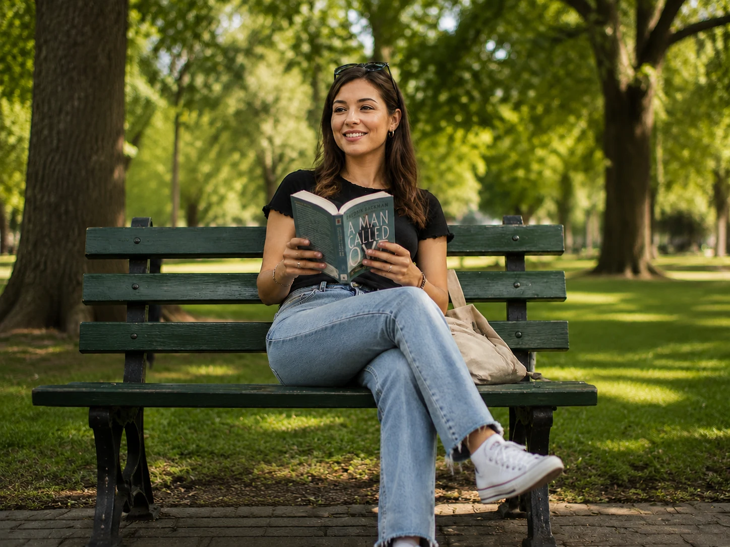 Woman reading on a park bench with the man, bicycle, and rubbish all removed, clean grass and park path visible behind her
