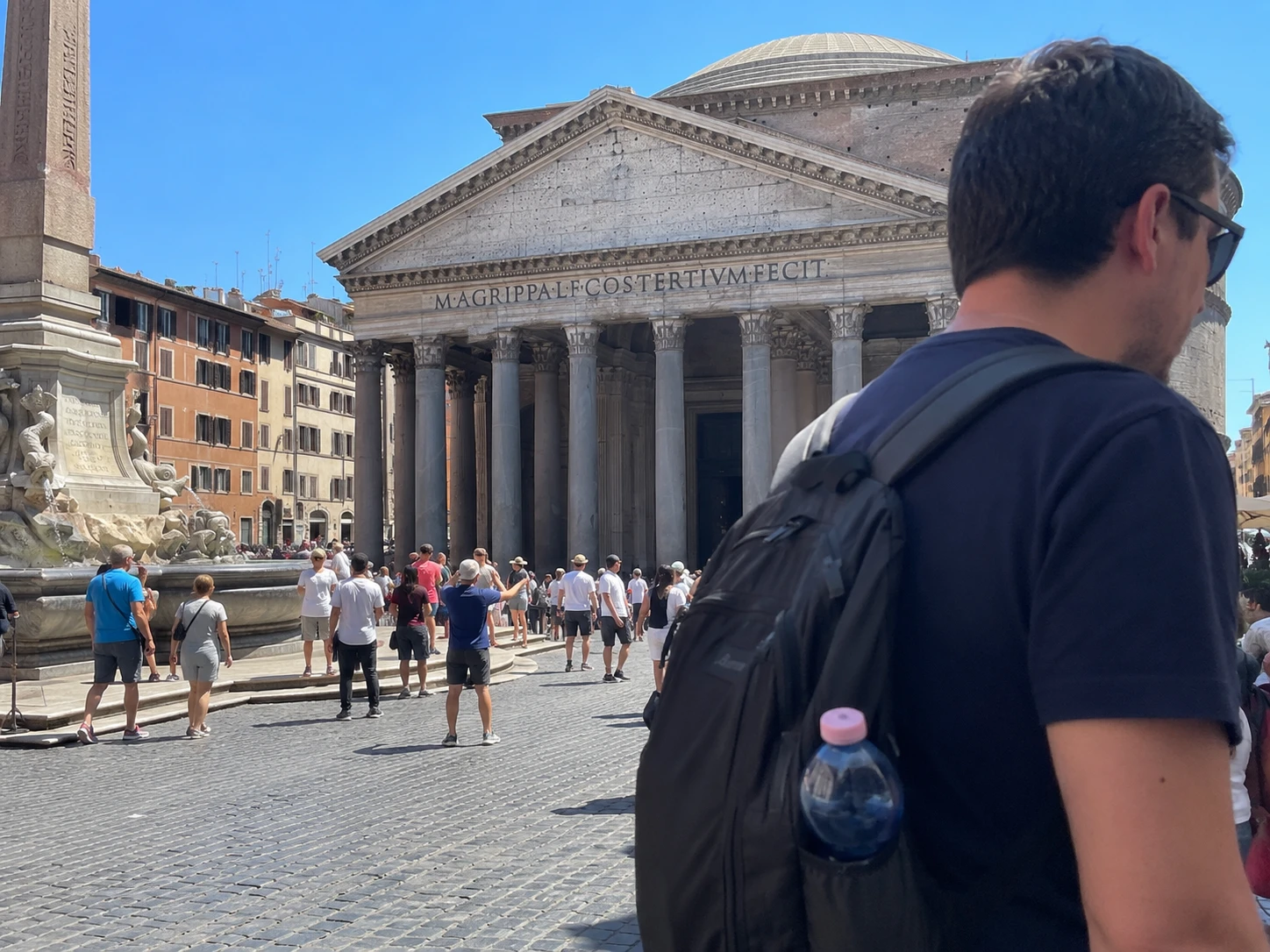 Travel photo of a city street with a stranger walking through the foreground