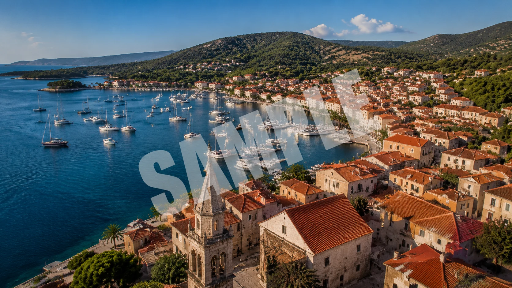 Aerial drone footage of a coastal town with a large diagonal 'SAMPLE' watermark stamped across the center of the frame