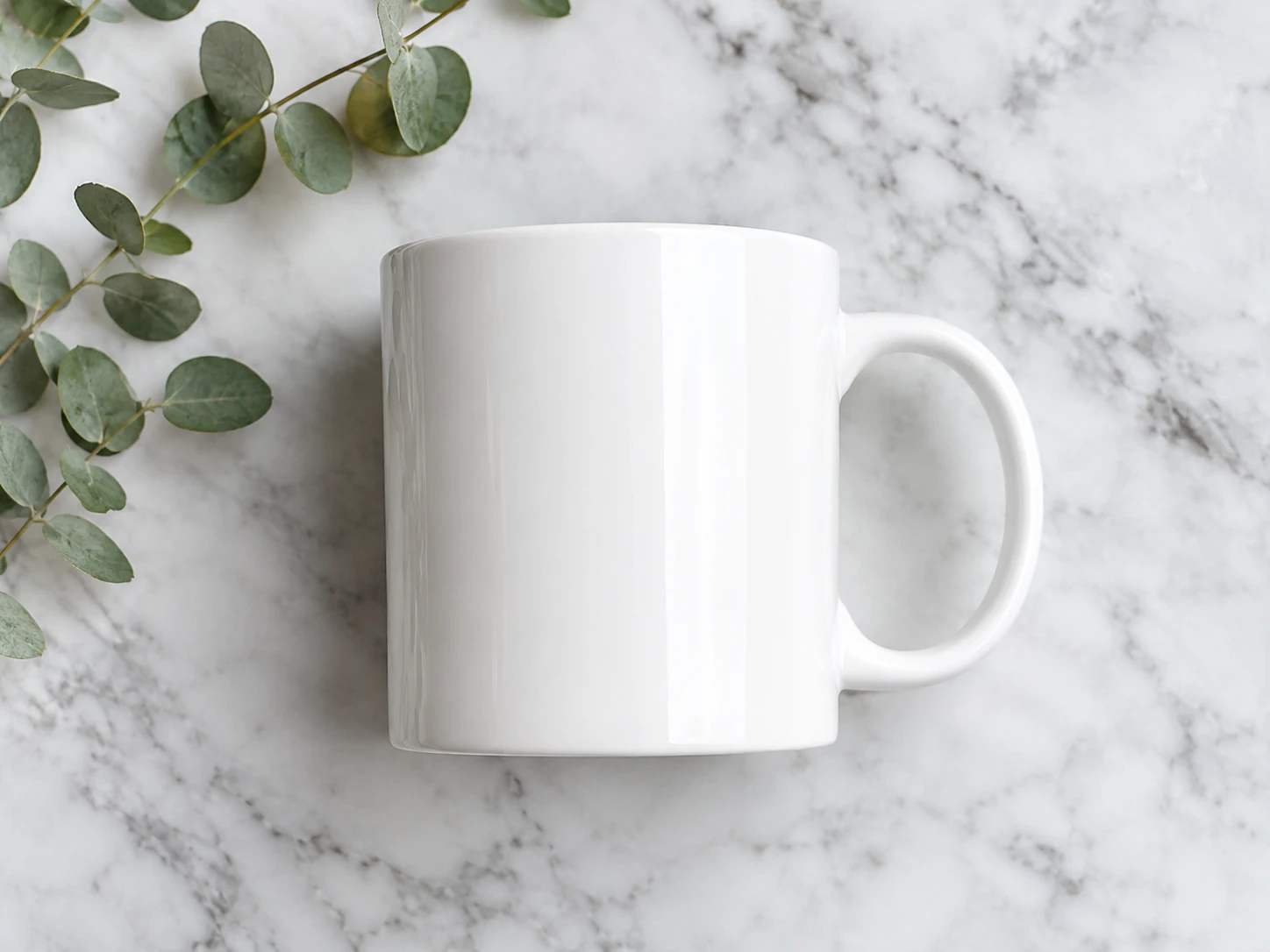 White ceramic coffee mug on a light gray marble surface