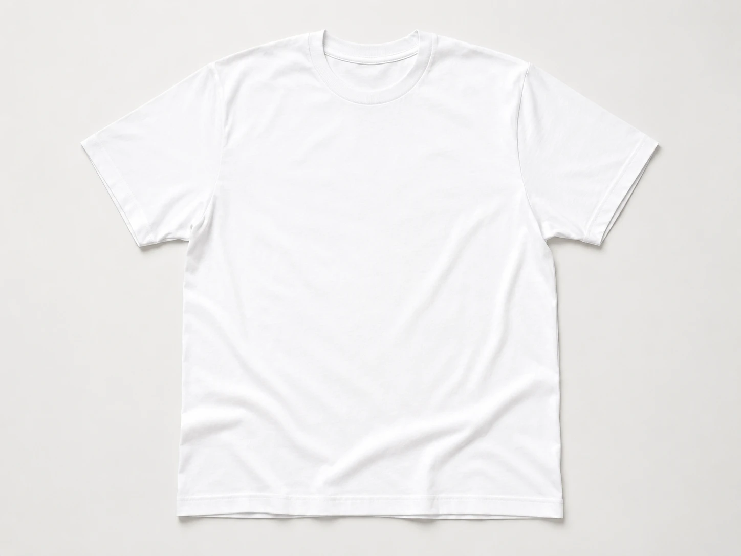 Clean white t-shirt mockup on a minimal flat surface