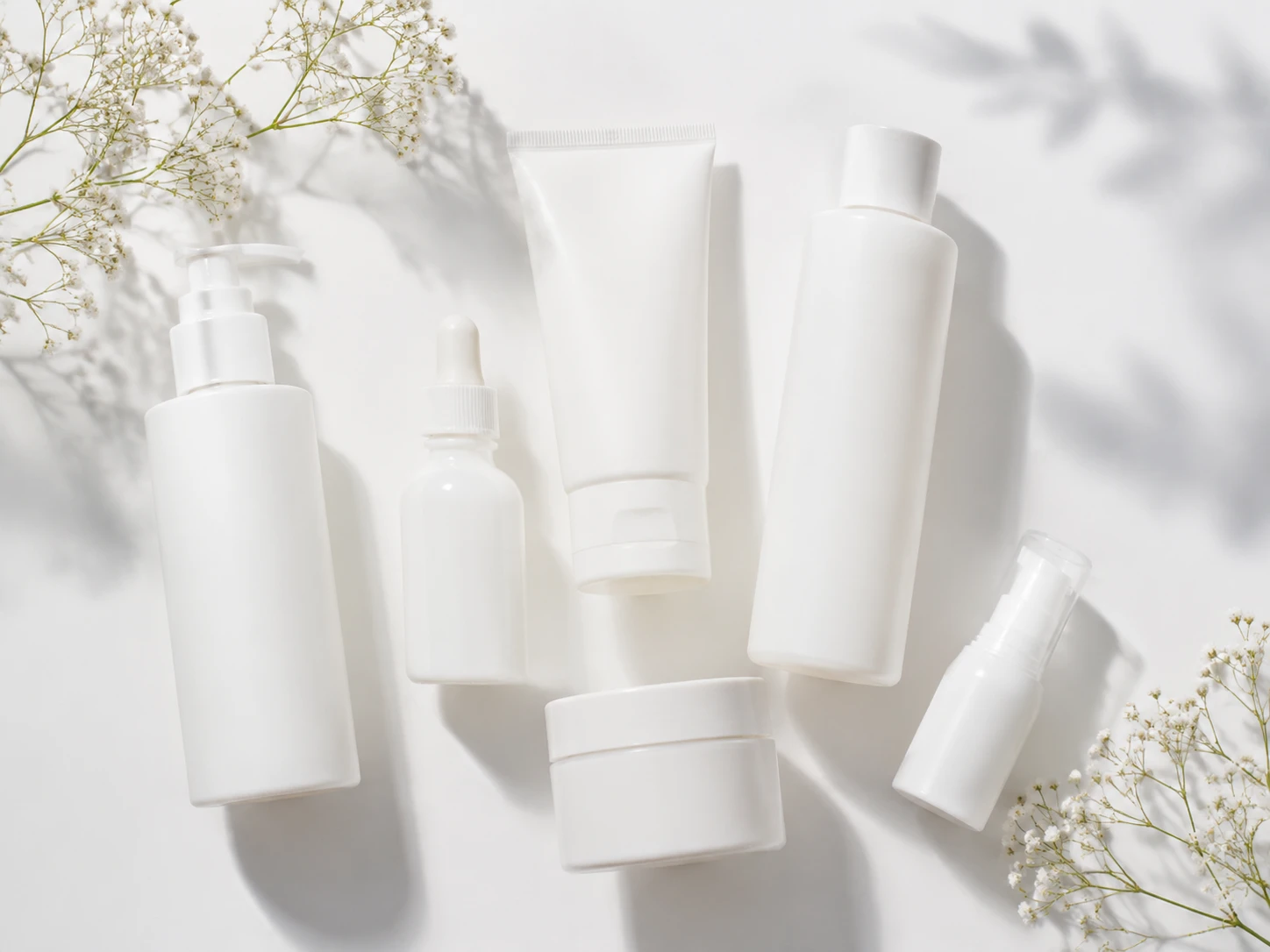 White skincare bottles on a clean white surface