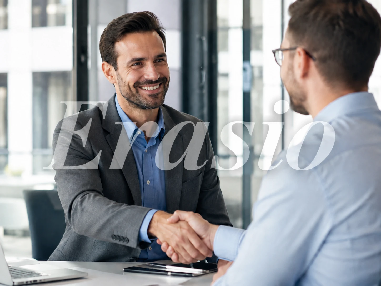 Office handshake photo with a centered gray Erasio preview watermark
